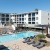 pool showing reclining seating and nearness to property buildings