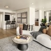 a living room with a couch and a coffee table near wet bar